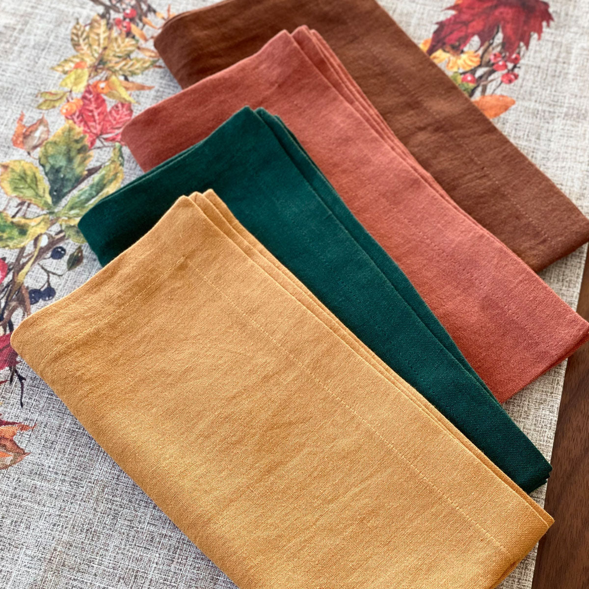 Stonewashed linen cotton blend napkins in warm hues perfect for Autumn, ranging from evergreen to chocolate