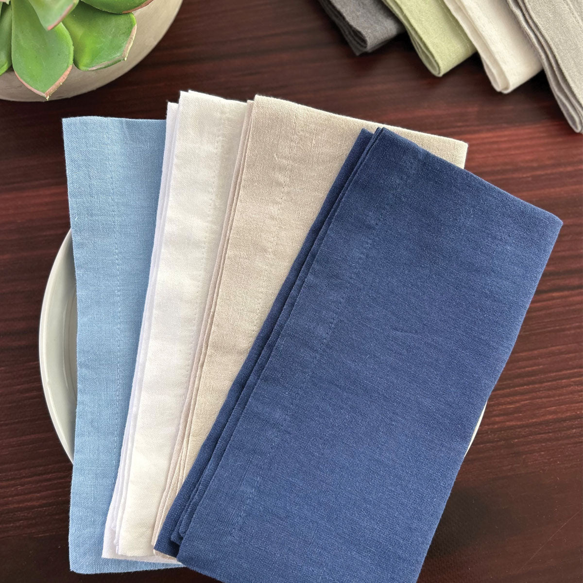 Linen cotton blend napkins that are incredibly soft and durable in soft colors, blue, white, and tan