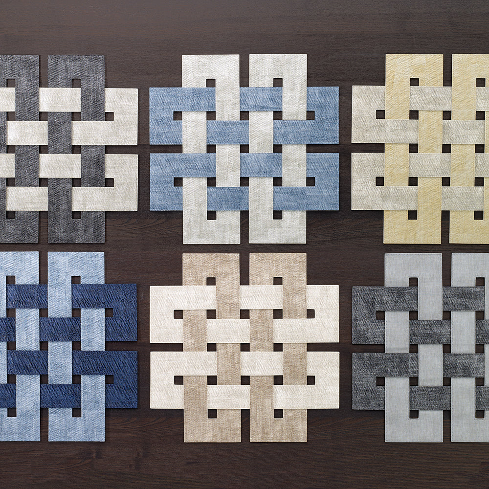 A collection of vinyl square placemats in various colors featuring a geometric Celtic knot design.