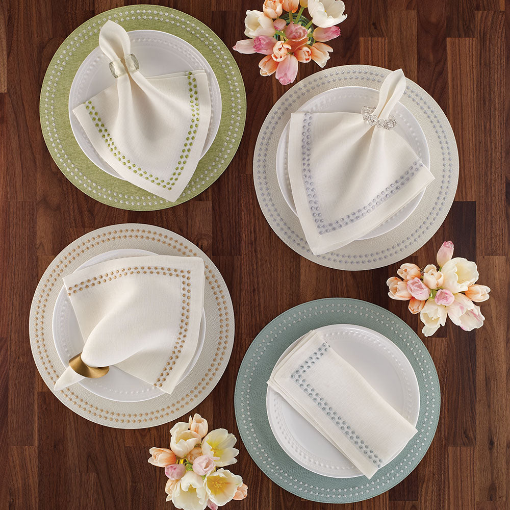 Variety of linen napkins with embroidered dots resembling pearls, with matching vinyl placemats with the same embroidered details. Willow, Silver, Gold and Celadon.