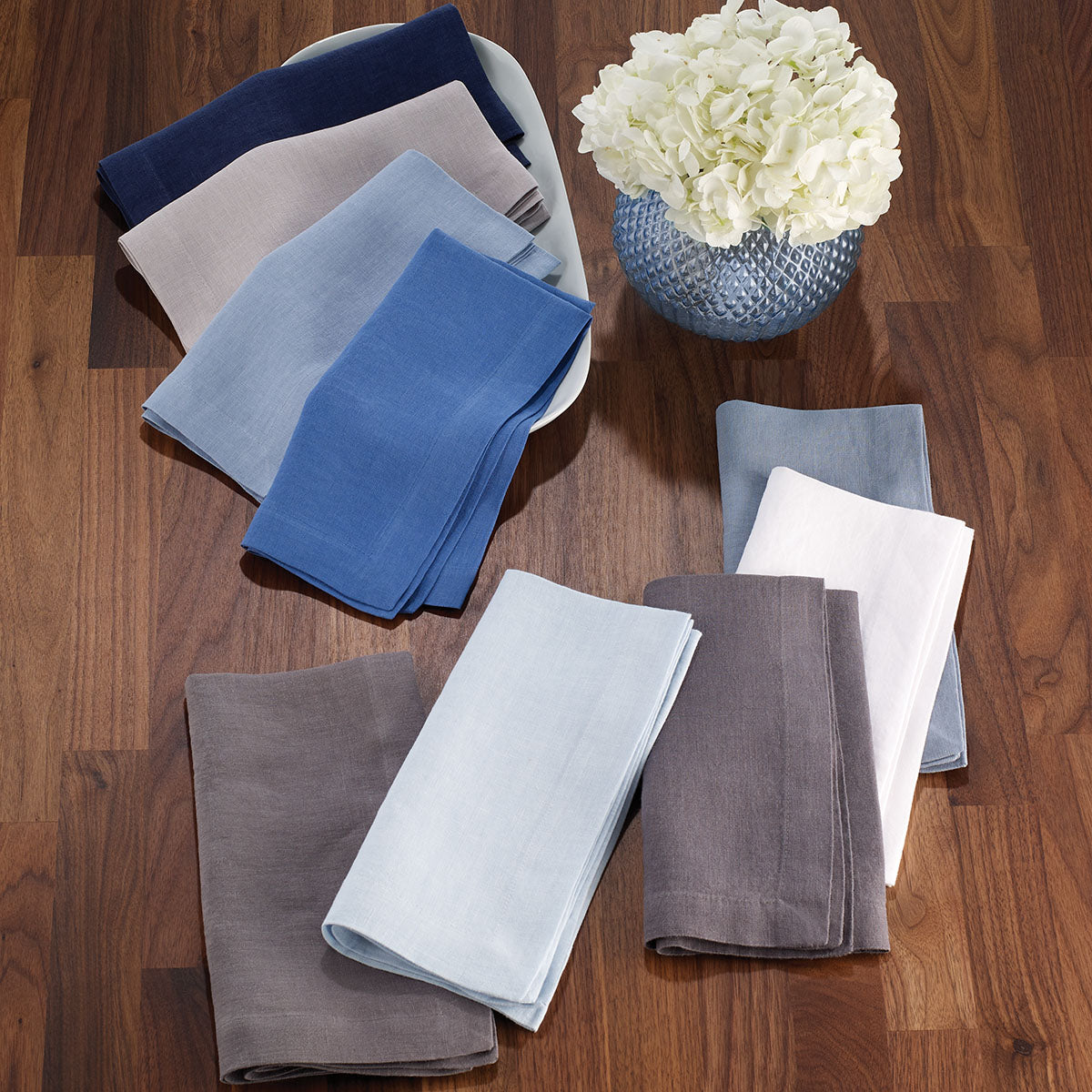Stonewashed linen napkins in cool colors from iceberg, powder blue, to gray and neutral tan.